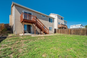 A two-story house with a wooden deck and a staircase leading to the second floor. - 1415 Legend Oak - Basement (Fountain)