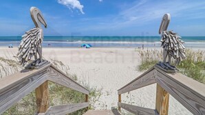 A beach with wooden railings and a large bird sculpture. - 226 South Fletcher 3rd Floor (Fernandina Beach)