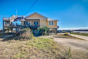 A two-story house with a balcony, a porch, and a fenced yard. - 623 Ocean Ave (Fernandina Beach)