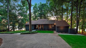 A modern house with a driveway, surrounded by trees. - Normandy Approach (Mooresville)