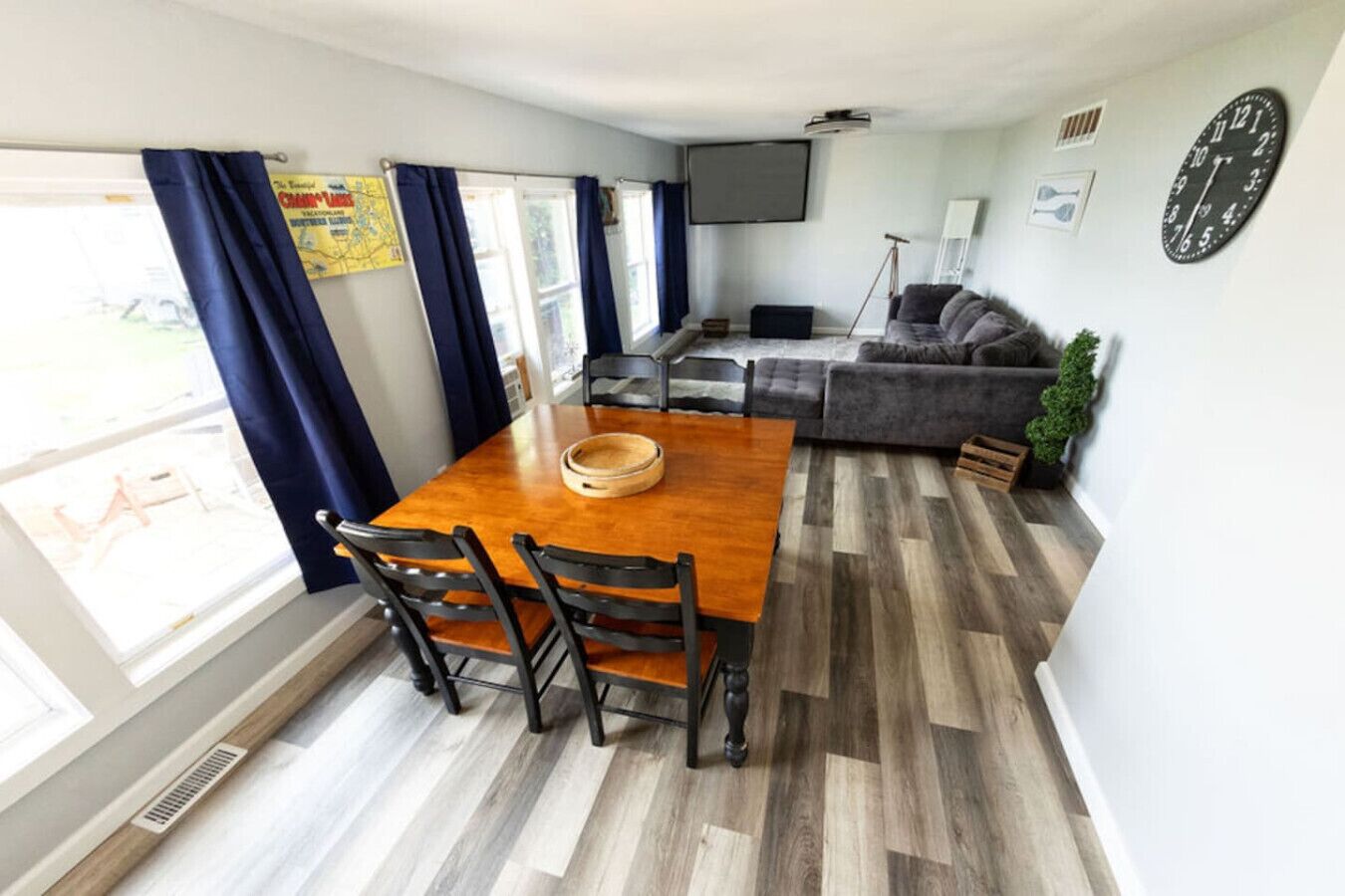 A compact living space with a dining table, chairs, a sofa, and a TV.