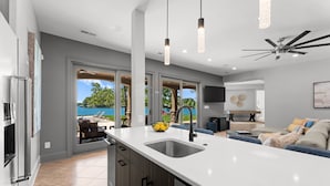 A modern kitchen with a large island, a built-in oven, and a view of the outdoors. - Sunset on Ballycastle (Mooresville)