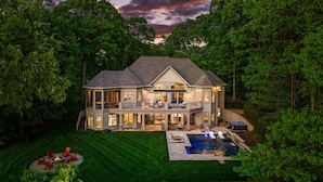 A large two-story house with a covered patio, a swimming pool, and a well-maintained lawn. - Sunset on Ballycastle (Mooresville)