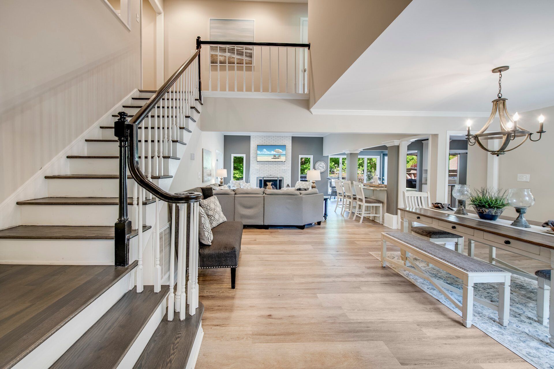 A spacious living area with a staircase, a dining area, and a kitchen.