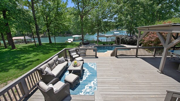 A deck with outdoor furniture, a pool, and a view of a lake. - Nights on Normandy (Mooresville)