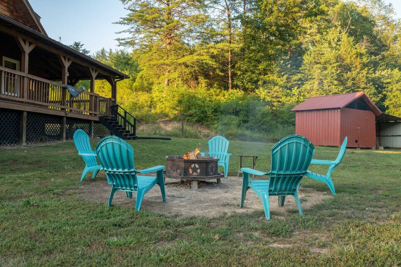 A wooden deck with outdoor seating and a fire pit.