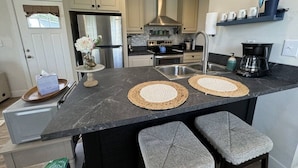 A modern kitchen with a central island, stainless steel appliances, and a built-in oven. - Wifi, Firepit, Fishing Pond - Farmview (Hazel Green)