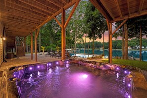 A hot tub area with a wooden deck and a view of a lake. - Northshore Landing (Denver)