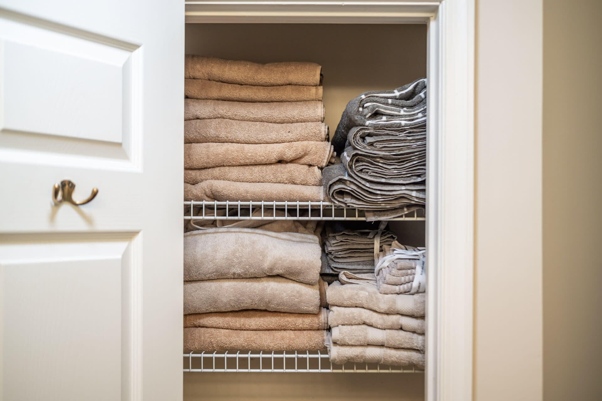 A closet with neatly folded towels and linens.