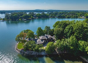 A lakeside property with a large house surrounded by trees and a dock. - The Chasestone (Mooresville)