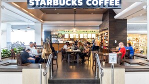 A Starbucks Coffee with indoor seating, a counter, and a staircase leading to the entrance. - Stunning Ala Moana 2501 (Honolulu)
