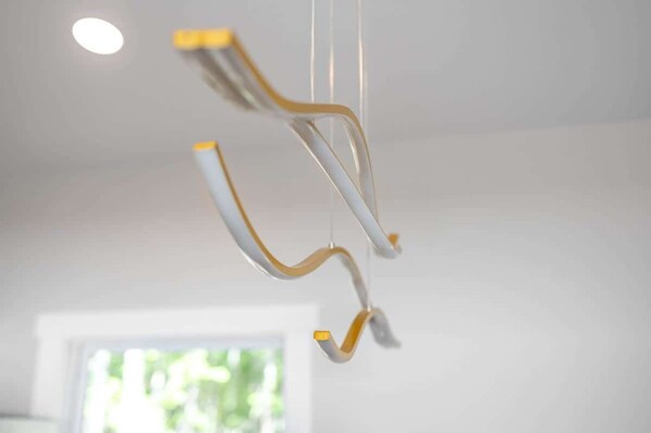 A modern, minimalist interior with a hanging light fixture.