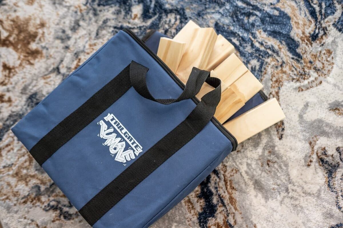 A blue bag with a black strap and the text 'EIGER GITE' on it, placed on a marble surface.