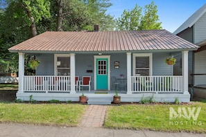 A single-story house with a porch, a front door, and two windows. - Lakeside Bungalow (Coeur d'Alene)