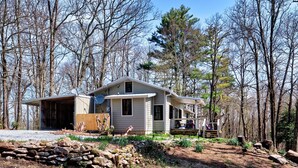 A modern house with a garage, surrounded by a forest. - The Pink Lady (Highlands)