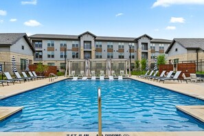 A rectangular swimming pool with a diving board in the center, surrounded by lounge chairs and umbrellas. - Gym, Pool, Washerdryer, Workerfriendly A+location (Sherman)