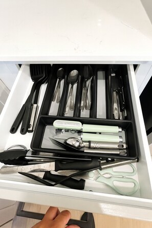 A drawer with various kitchen utensils including spoons, forks, and knives. - Gym, Pool, Washerdryer, Workerfriendly A+location (Sherman)
