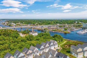 A residential area with houses, a marina, and a bridge over a river. - Sea La Vie Villa 3BD Beach Retreat Fence Yard (North Myrtle Beach)