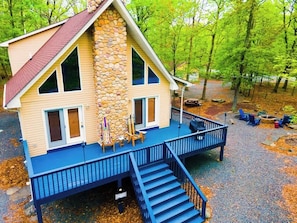 A two-story house with a stone facade, a blue deck, and a staircase leading to the entrance. - 4bdrm Games Family Frndly Fire Pit Masthope (Lackawaxen)