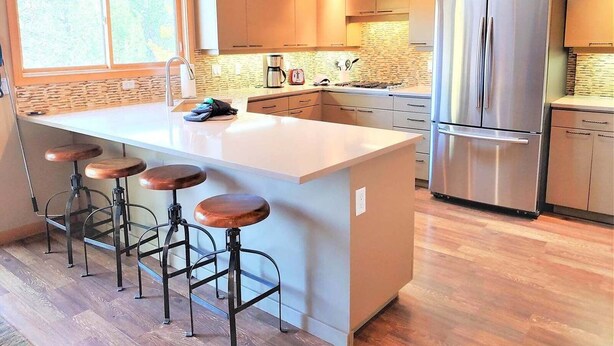 A modern kitchen with a large island, stainless steel appliances, and a skylight. - Lone Eagle Landing 2 (Bend)
