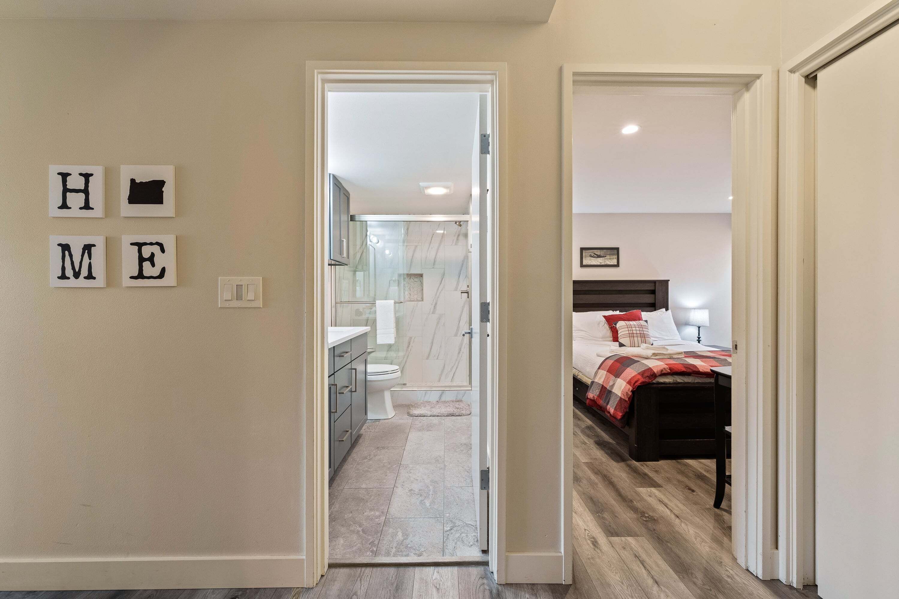 A bedroom with a bed, a bedside table, and a nightstand.