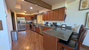 A modern kitchen with wooden cabinets, stainless steel appliances, and a granite countertop. - Indian 3 (Bend)