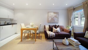 A modern living room with a dining area, a sofa, and a coffee table. - Hertford Flat 15 (London)