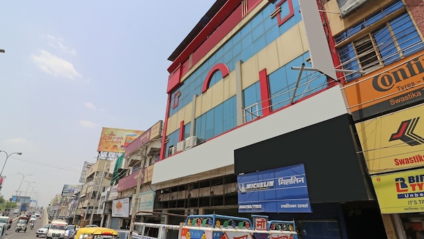 A multi-story building with commercial signage, including a tyre shop and a Michelin service center.
