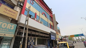 A multi-story building with commercial signage on the ground floor.