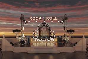 A stage with a sign reading "ROCK 'ROLL" and "LA CASTA STAR" against a sunset backdrop. - La Casta Star Cruise (Ha Long)