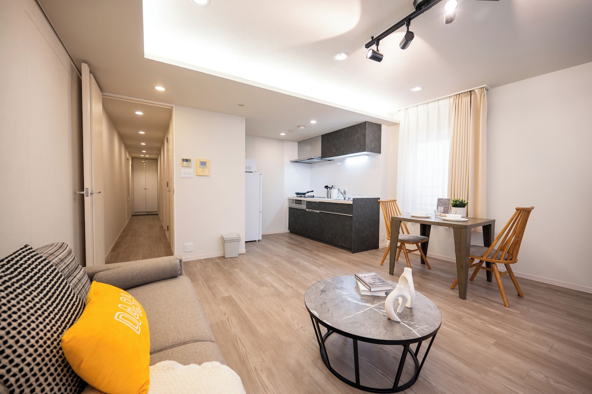 A modern apartment with a living area, dining space, and kitchen.