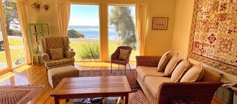 Absolute waterfront views, a cosy, country style retreat, set amongst the trees.