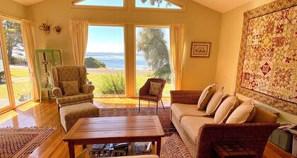 Absolute waterfront views, a cosy, country style retreat, set amongst the trees.