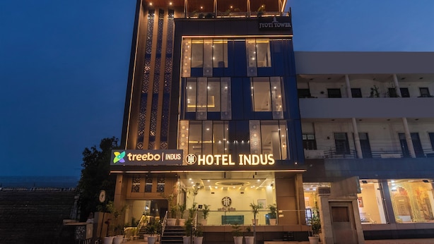 A hotel with a modern facade, large windows, and a sign for 'HOTEL INDUS.' - Treebo Indus (Jaipur)