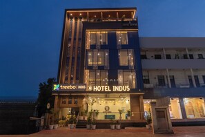 A hotel with a modern facade, large windows, and a sign for 'HOTEL INDUS.' - Treebo Indus (Jaipur)