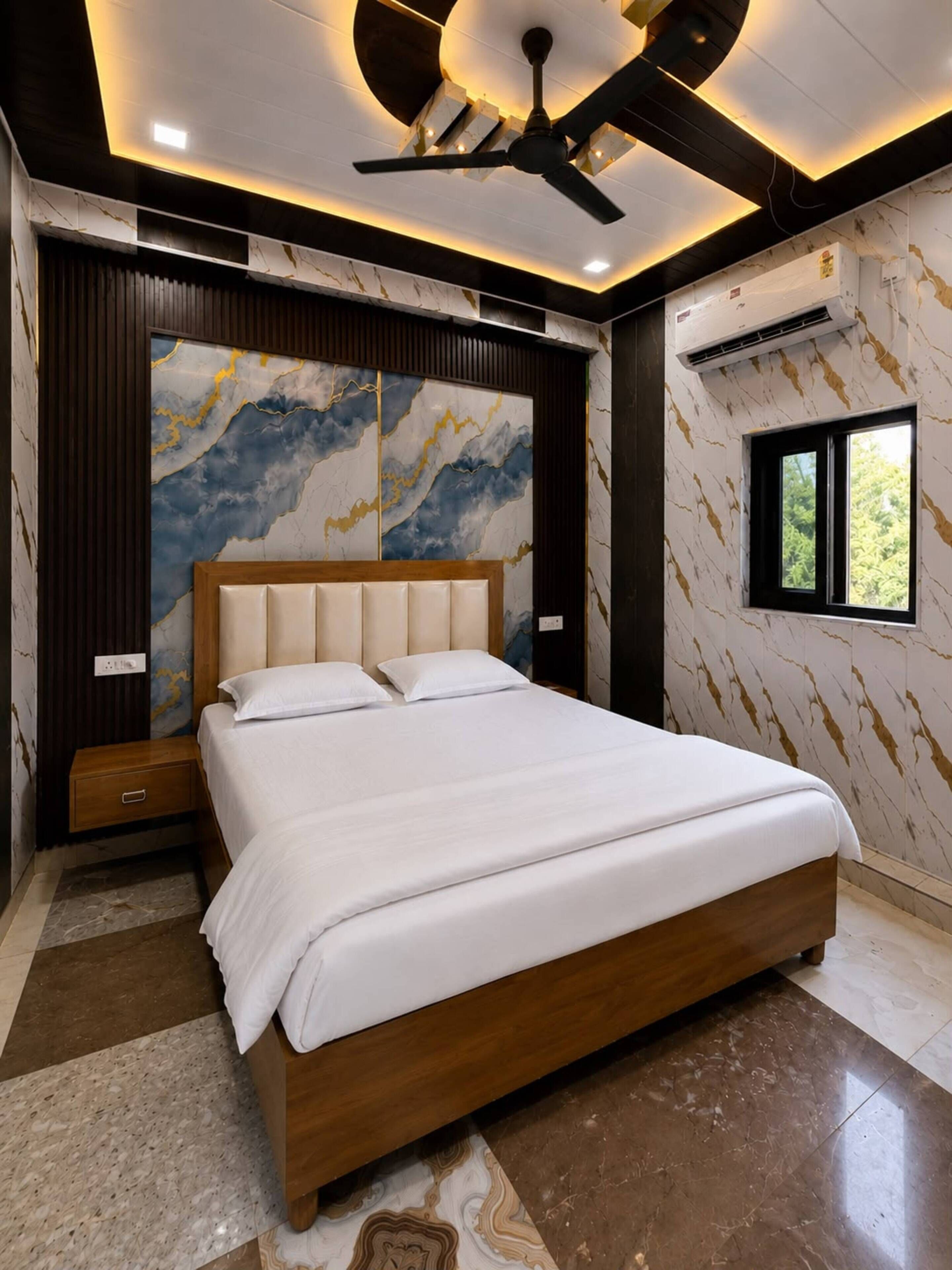 A modern bedroom with a bed, a ceiling fan, and a window.