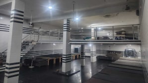 A multi-level parking garage with striped pillars, staircases, and a ventilation system. - Shri Laddu Gopal Dham (Mathura)