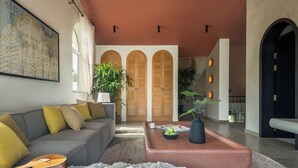A modern living room with a grey sofa, a coffee table, a guitar, and a large painting. - TBK VILLA VAGATOR   01 (Vagator)