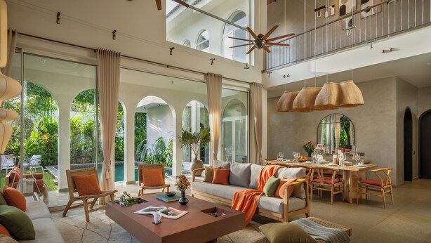 A spacious living area with a high ceiling, a dining table, and comfortable seating. - TBK VILLA VAGATOR   01 (Vagator)
