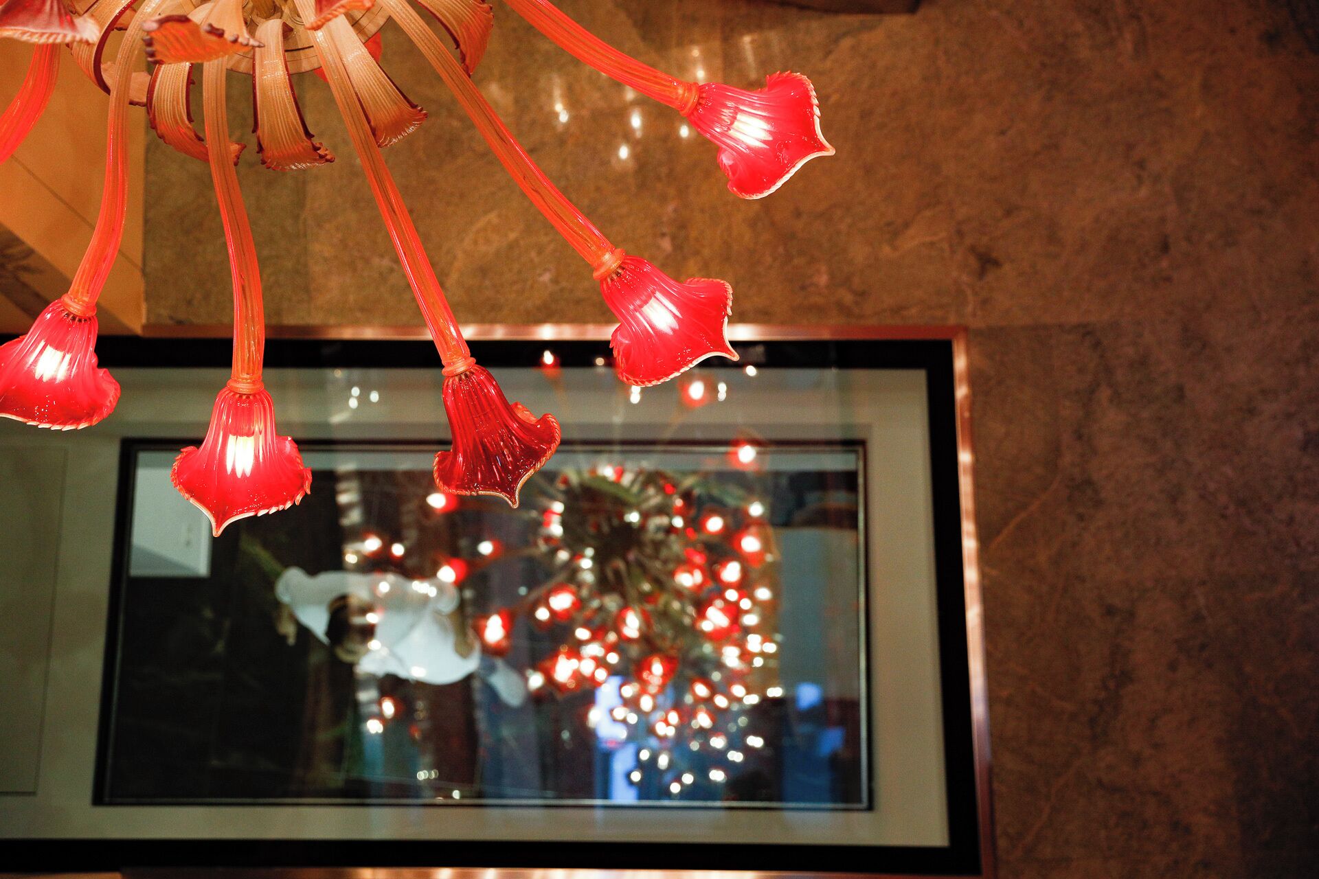 A chandelier with multiple red glass elements.