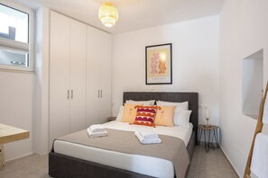 A bedroom with a bed, bedside table, lamp, and wardrobe. - [NEW] J & I Rooftop Retreat in a small village (89H2+F36 Karoti, Greece)