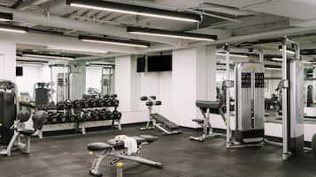 A gym with exercise equipment, mirrors, and a clean, modern design.