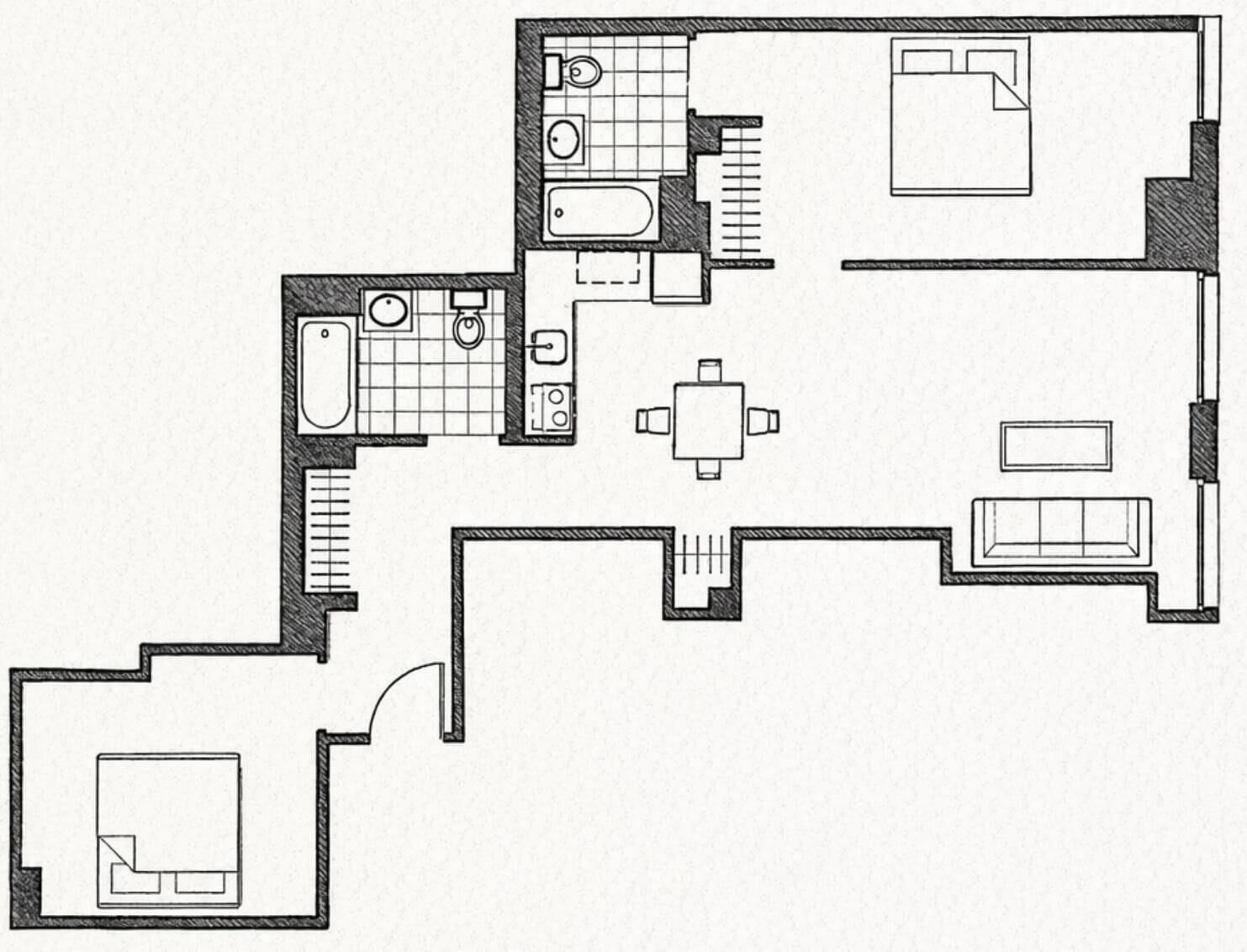 A floor plan of a hotel room with a bathroom, a small dining area, a living area with a sofa, and a separate bedroom.