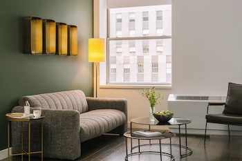 A gym with exercise equipment, mirrors, and a clean, modern design. at Nester Finn Financial District