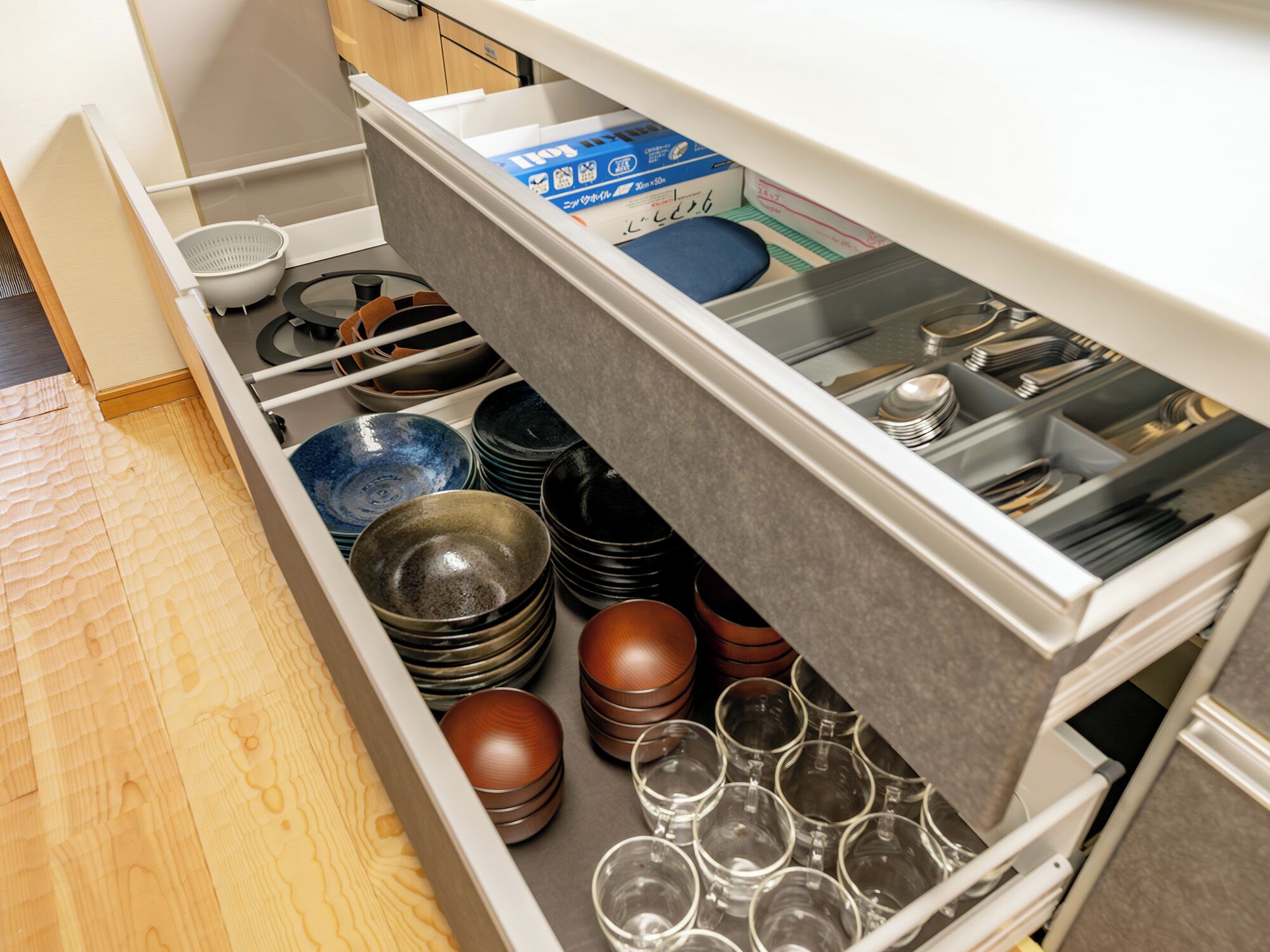 A kitchen drawer with neatly organized dishes and utensils.