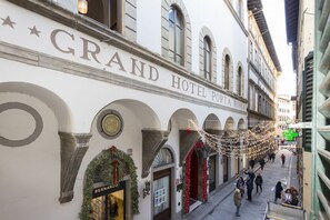 The Grand Hotel Porta Rossa facade with arched windows and a sign above the entrance. - Stylish Renovated 2-Bedroom Apartment Steps from the Uffizi (Firenze)