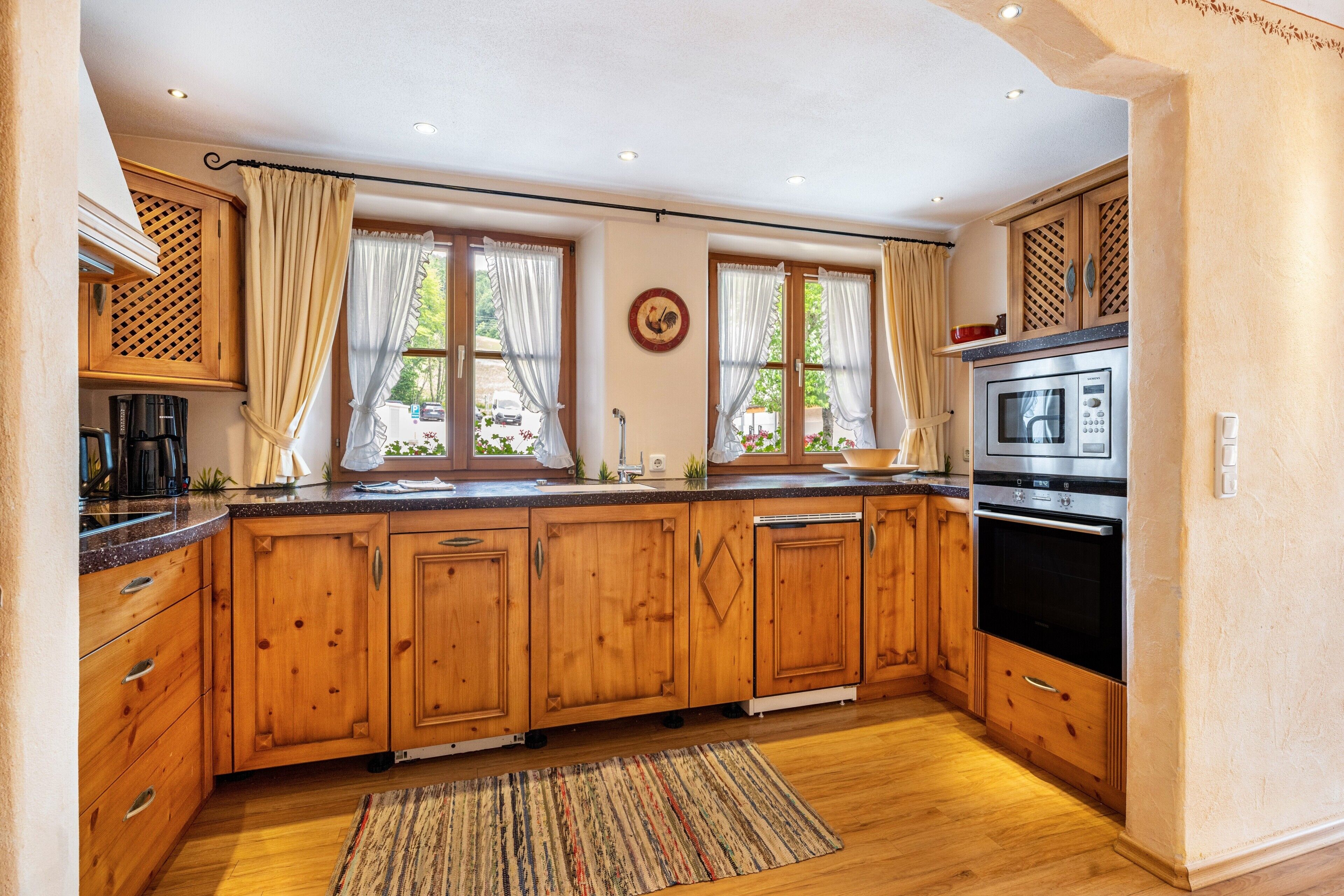 A kitchen with wooden cabinets, a microwave, and a coffee maker.