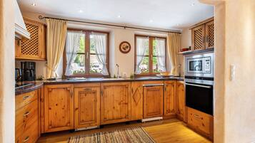 A kitchen with wooden cabinets, a microwave, and a coffee maker.