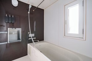 A modern bathroom with a bathtub, a shower, and a large window. - MP STYLE SAPPORO-50 (Sapporo)