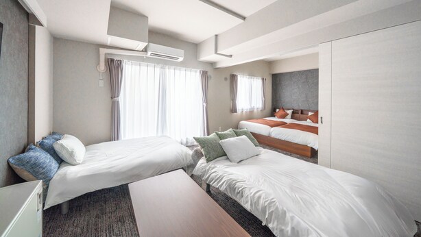 A hotel room with two beds, a desk, and a wardrobe. - MP STYLE SAPPORO-50 (Sapporo)